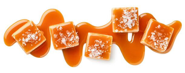 Five salty or salted caramel candy cubes topped with caramel sauce and sea salt on white background
