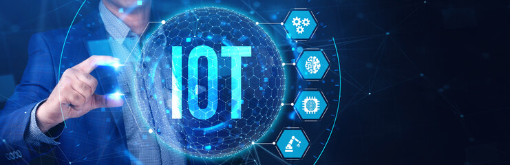 Internet of things - IOT concept. Businessman offer IOT products and solutions. The future of technology. Virtual screen of the future with the inscription: IOT.