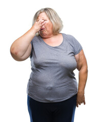 Senior plus size caucasian woman over isolated background smelling something stinky and disgusting, intolerable smell, holding breath with fingers on nose. Bad smells concept.