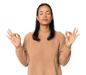 Young Filipina woman relaxes after hard working day, she is performing yoga.