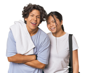 Young interracial athletic couple in studio laughing and having fun.