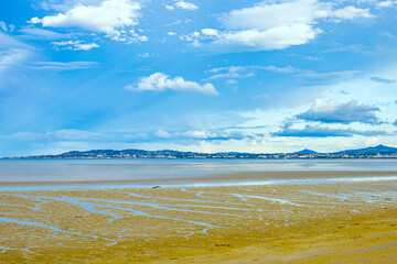 Dublin, Ireland - wetland beach under blue sky and white clouds