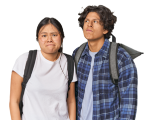 Young interracial student couple studying confused, feels doubtful and unsure.