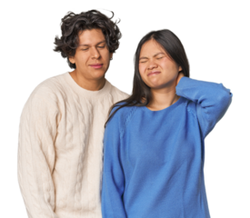 Young interracial couple in studio suffering neck pain due to sedentary lifestyle.