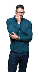 Fototapeta premium Young handsome business man wearing glasses over isolated background looking stressed and nervous with hands on mouth biting nails. Anxiety problem.
