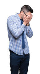 Young business man wearing glasses over isolated background with sad expression covering face with hands while crying. Depression concept.