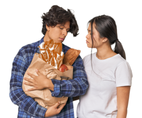 Multiracial young couple shopping for groceries in studio