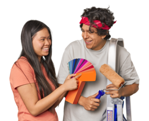 Happy multiracial couple with painting tools in studio
