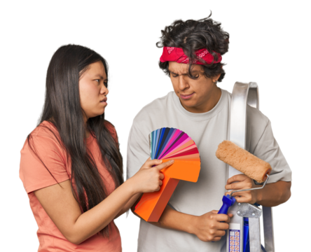 Happy multiracial couple with painting tools in studio