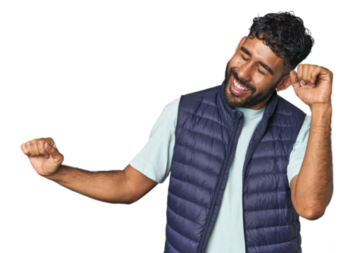 Young Hispanic man isolated dancing and having fun.