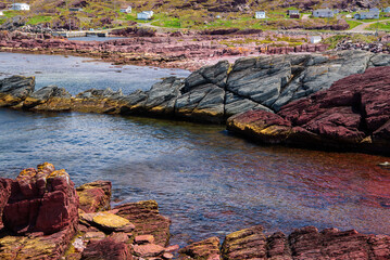 The coastline of Tickle Cove, situated on the Discovery Trail of the Bonavista Peninsula in Eastern Newfoundland, is decorated with vibrantly colored rocks.