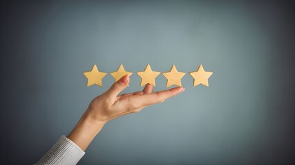 Woman's hand holds five stars on a row on a light blue background