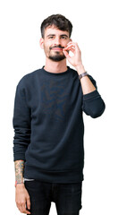 Young handsome man over isolated background mouth and lips shut as zip with fingers. Secret and...
