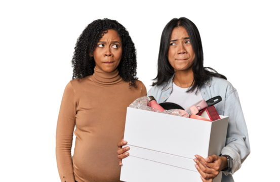 Latin women couple moving, one pregnant  confused, feels doubtful and unsure.