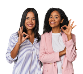 Young Latin businesswomen in studio winks an eye and holds an okay gesture with hand.