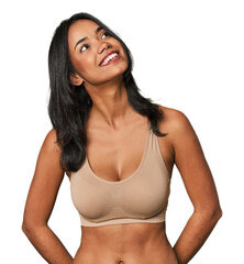 Fototapeta premium Young Filipino woman in light wear relaxed and happy laughing, neck stretched showing teeth.