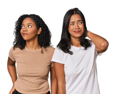 Young Latin friends in studio touching back of head, thinking and making a choice.