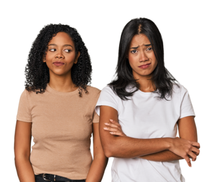 Young Latin friends in studio unhappy looking in camera with sarcastic expression.