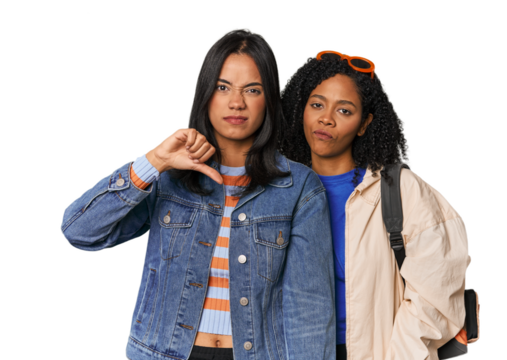 Latin friends ready for vacation showing thumb down, disappointment concept.