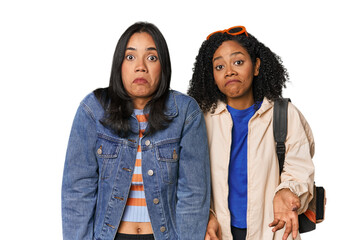 Fototapeta premium Latin friends ready for vacation shrugs shoulders and open eyes confused.
