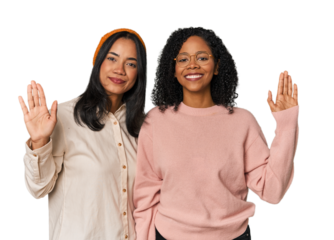 Young Latin friends together in studio smiling cheerful showing number five with fingers.