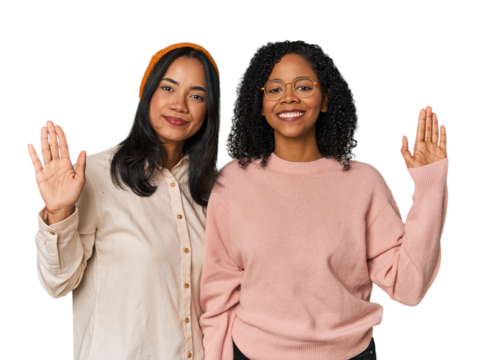 Young Latin friends together in studio smiling cheerful showing number five with fingers.