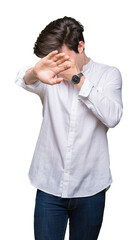 Young handsome business man over isolated background covering eyes with hands and doing stop gesture with sad and fear expression. Embarrassed and negative concept.