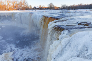 Partially frozen waterfall Jagala juga, Estonia. Water falling from fractured limestone plate