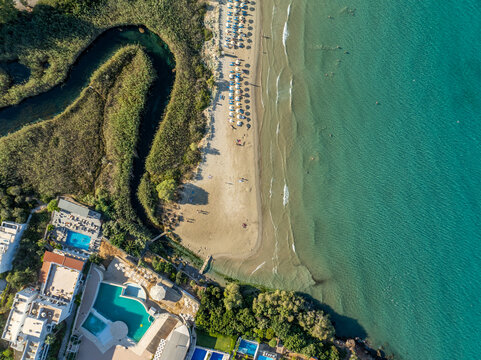 Greece - Crete - The famous Almyros beach is one of the most beautiful sandy beaches in Crete, with a small stream flowing into the sea nearby. The town of Agios Nikolaos is nearby