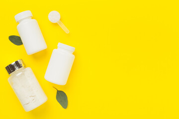 Jars with protein powder on color background, top view. Sports nutrition concept