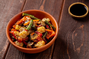 vegetables stewed in spices in a clay bowl on the table