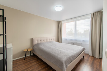 Minimalism Bedroom Interior. Wardrobe in Background. Coffee Table and Light. Windows and Curtains. Home.