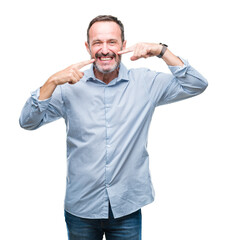 Fototapeta premium Middle age hoary senior business man over isolated background smiling confident showing and pointing with fingers teeth and mouth. Health concept.