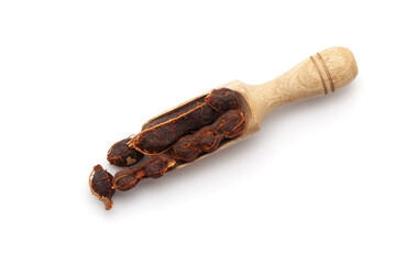 Top view of a wooden scoop filled with Fresh Organic Sweet Tamarind (Tamarindus indica) Fruit. Isolated on a white background.
