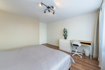 Minimalism Young Adult Living Room Interior. Bed and Coffee Table. Gray Blanket on the Bed. Windows and Curtains. LED Light. Windows and Curtains