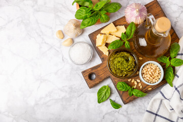 Pesto. Italian basil pesto sauce on a textured wooden background. Ingredient for pesto sauce: fresh...