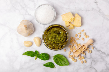 Pesto. Italian basil pesto sauce on a textured wooden background. Ingredient for pesto sauce: fresh...