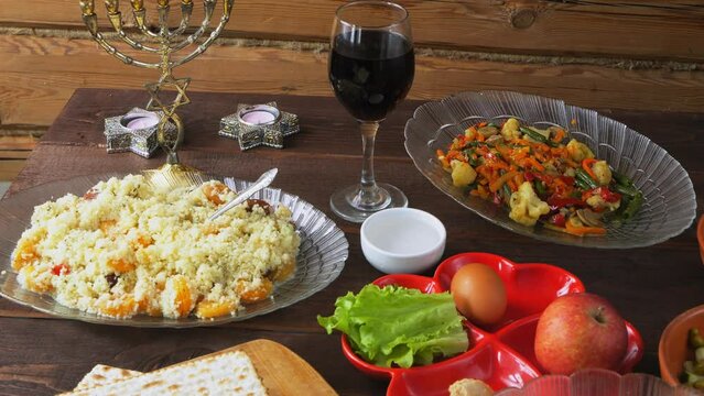 The Pesach Seder table is festively set with matzo candles and wine. General plan