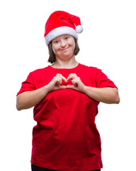 Young adult woman with down syndrome wearing christmas hat over isolated background smiling in love showing heart symbol and shape with hands. Romantic concept.