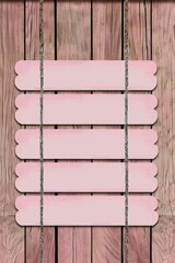 5 light pink wooden slats on the wall, 5 blank horizontal signs hanging side by side in the style of side. The background is a textured wood paneling surface.