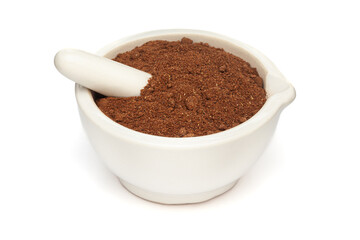 Close-up of Organic Soapnut or Reetha (Sapindus mukorossi) powder with its Fruits, in white ceramic mortar and pestle, isolated on a white background.