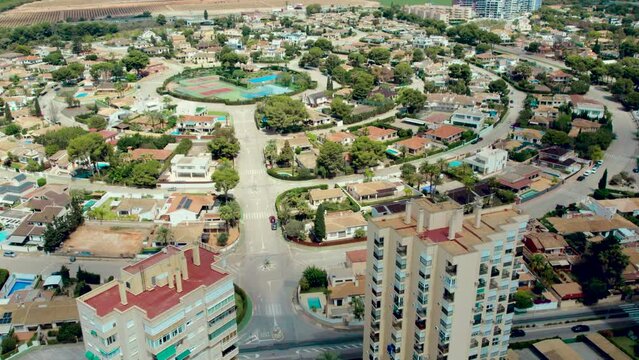 Aerial view Dehesa de Campoamor, village in Orihuela Costa. Residential area with houses surrounded by greenery, apartment buildings near coastline, roads around neighborhood, Mediterranean Sea. Spain