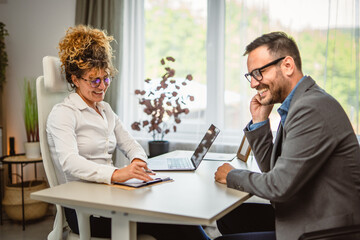 Man colleague have consultation at woman colleague office