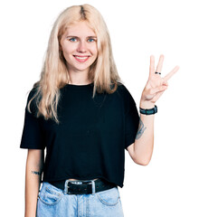 Obraz premium Young caucasian woman wearing casual clothes showing and pointing up with fingers number three while smiling confident and happy.