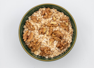 Delicious nutritious and healthy fresh old fashioned oatmeal on white background , top view
