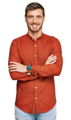 Handsome caucasian man wearing casual clothes happy face smiling with crossed arms looking at the...