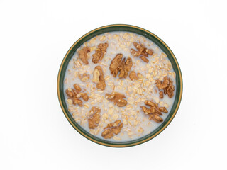 Delicious nutritious and healthy fresh old fashioned oatmeal on white background , top view