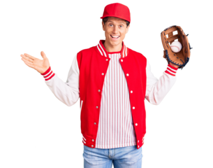 Young handsome man wearing baseball uniform holding golve and ball celebrating victory with happy smile and winner expression with raised hands