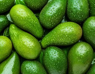 Creative food concept. Fresh avocados avocado green adorned with glistening water droplets...