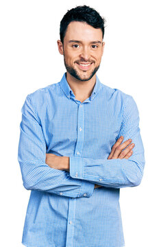 Hispanic man with beard with arms crossed gesture smiling with a happy and cool smile on face. showing teeth.